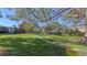 Landscaped community lawn with mature trees and a paved walkway at 5152 Marsh Field Ln # 117, Sarasota, FL 34235