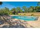 Inviting community pool with ample lounge chairs at 5152 Marsh Field Ln # 117, Sarasota, FL 34235