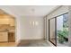 Bright dining area with sliding glass doors leading to a private patio at 5152 Marsh Field Ln # 117, Sarasota, FL 34235