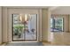 View of patio from dining area with sliding glass doors at 5152 Marsh Field Ln # 117, Sarasota, FL 34235