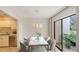 Modern dining area with marble table and access to a private patio at 5152 Marsh Field Ln # 117, Sarasota, FL 34235