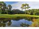 Landscaped golf course with pond and trees at 5152 Marsh Field Ln # 117, Sarasota, FL 34235