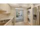 Kitchen with stainless steel appliances and access to patio at 5152 Marsh Field Ln # 117, Sarasota, FL 34235