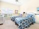Bedroom with two twin beds, window and carpet at 5440 Eagles Point Cir # 405, Sarasota, FL 34231