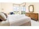 Main bedroom with water views, large windows and sliding doors to balcony at 5440 Eagles Point Cir # 405, Sarasota, FL 34231