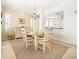 Bright dining room features a light wood table with seating for six and a large chandelier at 5440 Eagles Point Cir # 405, Sarasota, FL 34231