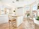 Kitchen features white cabinets, granite island, breakfast nook, and sunny window at 5440 Eagles Point Cir # 405, Sarasota, FL 34231