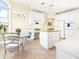 Bright kitchen with white cabinets, granite island, and built-in desk area at 5440 Eagles Point Cir # 405, Sarasota, FL 34231