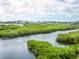 Scenic waterfront view with lush mangrove vegetation at 5440 Eagles Point Cir # 405, Sarasota, FL 34231