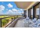 Outdoor balcony with seating and golf course view at 545 Sanctuary Dr # A803, Longboat Key, FL 34228