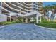 Condo building entrance with circular driveway at 545 Sanctuary Dr # A803, Longboat Key, FL 34228