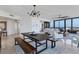 Modern dining area with a rustic wood table and benches at 545 Sanctuary Dr # A803, Longboat Key, FL 34228