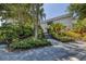 Landscaped entrance with paved pathway to building at 545 Sanctuary Dr # A803, Longboat Key, FL 34228