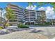 Elegant beachfront condo building with landscaped grounds and courtyard at 545 Sanctuary Dr # A803, Longboat Key, FL 34228