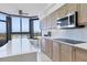 Updated kitchen features light wood cabinets and a large island with white countertops at 545 Sanctuary Dr # A803, Longboat Key, FL 34228