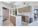 Modern kitchen with ample cabinet space and island, open to living area at 545 Sanctuary Dr # A803, Longboat Key, FL 34228