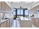 Modern kitchen with stainless steel appliances and island, offering stunning water views at 545 Sanctuary Dr # A803, Longboat Key, FL 34228