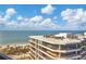 Stunning ocean view from condo balcony featuring beach and palm trees at 545 Sanctuary Dr # A803, Longboat Key, FL 34228