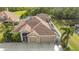 House with solar panels and a three-car garage, near a lake at 5554 New Covington Dr, Sarasota, FL 34233