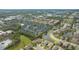 Wide aerial showcasing the home's location in a residential neighborhood at 5554 New Covington Dr, Sarasota, FL 34233
