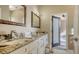 Bathroom boasts a granite countertop, double vanity, and access to backyard at 5554 New Covington Dr, Sarasota, FL 34233