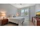 Bright bedroom with a queen bed, window, and wood floors at 5554 New Covington Dr, Sarasota, FL 34233