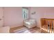 Charming bedroom with a crib and armchair, perfect for a Bedroom at 5554 New Covington Dr, Sarasota, FL 34233