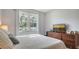 Bright bedroom with a queen bed and wood dresser at 5554 New Covington Dr, Sarasota, FL 34233