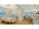 Open concept dining room with light floors and a farmhouse table at 5554 New Covington Dr, Sarasota, FL 34233