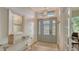 Bright entryway with light wood floors and a large mirror at 5554 New Covington Dr, Sarasota, FL 34233