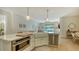 Spacious kitchen island with marble countertops and farmhouse sink at 5554 New Covington Dr, Sarasota, FL 34233