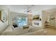 Bright living room with fireplace and sliding glass doors to pool at 5554 New Covington Dr, Sarasota, FL 34233