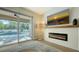 Living room features a fireplace and sliding glass doors leading to the pool at 5554 New Covington Dr, Sarasota, FL 34233