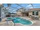 Inviting pool area with screened enclosure, spa, and patio furniture at 5554 New Covington Dr, Sarasota, FL 34233