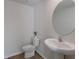 Simple bathroom with pedestal sink and round mirror at 5846 Silver Moonlight Dr, Palmetto, FL 34221