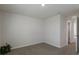 Spacious bedroom with grey carpet and door to hallway at 5846 Silver Moonlight Dr, Palmetto, FL 34221