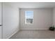 Simple bedroom with grey carpet and window at 5846 Silver Moonlight Dr, Palmetto, FL 34221