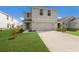 Two-story house with a two-car garage and landscaped lawn at 5846 Silver Moonlight Dr, Palmetto, FL 34221