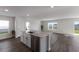 Open concept kitchen with white cabinets and stainless steel appliances at 5846 Silver Moonlight Dr, Palmetto, FL 34221