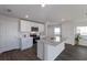 Open concept kitchen with white cabinets and island at 5846 Silver Moonlight Dr, Palmetto, FL 34221