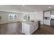 Modern kitchen with white cabinets, island, and stainless steel appliances at 5846 Silver Moonlight Dr, Palmetto, FL 34221