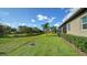 Backyard with canal view and lush greenery at 6337 Rivo Lakes Blvd, Sarasota, FL 34241