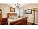 Comfortable bedroom with a sleigh bed and beautiful artwork at 6337 Rivo Lakes Blvd, Sarasota, FL 34241
