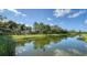 Serene view of a canal reflecting the beautiful sky at 6337 Rivo Lakes Blvd, Sarasota, FL 34241