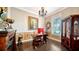 Elegant home office features hardwood floors, built-in shelving, and large window at 6337 Rivo Lakes Blvd, Sarasota, FL 34241