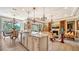 Gourmet kitchen with granite countertops and island at 6337 Rivo Lakes Blvd, Sarasota, FL 34241