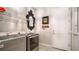 Laundry room with washer, dryer, and ample shelving at 6337 Rivo Lakes Blvd, Sarasota, FL 34241