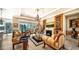 Spacious living room with a fireplace and access to outdoor space at 6337 Rivo Lakes Blvd, Sarasota, FL 34241