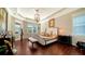 Spacious main bedroom with king-size bed and dark wood floors at 6337 Rivo Lakes Blvd, Sarasota, FL 34241