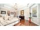 Bright main bedroom with king-size bed, hardwood floors, and artwork at 6337 Rivo Lakes Blvd, Sarasota, FL 34241